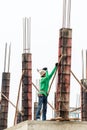 Worker mounter assembling concrete formwork with hammer