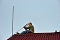 A worker mounts a individual UHF television antenna Royalty Free Stock Photo