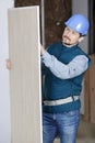 worker moving boards within residential construction site