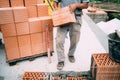 worker moving bricks and using tools for building exterior walls with bricks and mortar Royalty Free Stock Photo