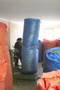 Worker Moving Large Sack Full Of Coca Leaves At The Coca Leaves Depot In Chulumani