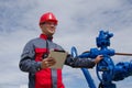 Worker near well head valve Royalty Free Stock Photo