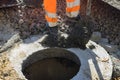 A worker the new road construction work on preparation for installation of sewer hatches Royalty Free Stock Photo