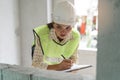 Worker occupation. Woman inspector / architect checking interior material process in house reconstruction project Royalty Free Stock Photo