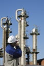 Worker and oil towers Royalty Free Stock Photo