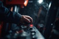 Operator adjusts controls on heavy machinery during rainy night work at construction site Royalty Free Stock Photo