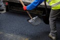 Worker operating asphalt paver machine during road construction. Royalty Free Stock Photo