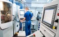 Worker operating CNC machine center Royalty Free Stock Photo