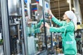 Worker operating conveyor or labeling machine at factory Royalty Free Stock Photo