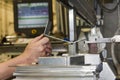 Worker operating metal press machine at workshop Royalty Free Stock Photo
