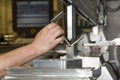 Worker operating metal press machine at workshop Royalty Free Stock Photo