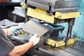 Worker operating metal sheet press machine Royalty Free Stock Photo