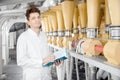 Worker operator checks mill production line of cereals, flour, millet and seeds. Food industry service concept