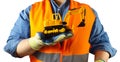 Worker in orange jacket outfit holding excavator toy Royalty Free Stock Photo