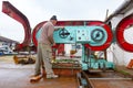 Carpenter adjusts the machine for cutting, woodworking