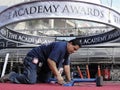 A worker at The Academy Awards smooths out the red carpet Royalty Free Stock Photo