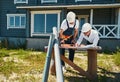 Worker in overalls putting spirit level on drawings Royalty Free Stock Photo