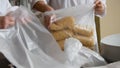 Worker packaging macaroni from the conveyor belt in a pasta factory