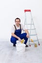 Worker with paint, brush and ladder Royalty Free Stock Photo