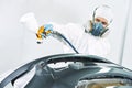 Worker painting auto car bumper Royalty Free Stock Photo