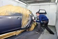 Worker painting a car.