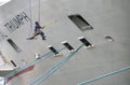 Worker Painting A Cruise Ship Docked in the Hudson River, New York, USA