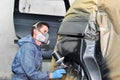 Worker painting gray car. Royalty Free Stock Photo