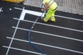 Worker painting a pedestrian crosswalk road Royalty Free Stock Photo