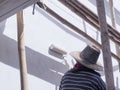 A worker is painting the walls of the house with a primer using a paint roller Royalty Free Stock Photo