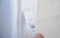 A worker is painting the walls of the house with a primer using a paint roller Royalty Free Stock Photo