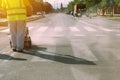 Worker is painting zebra pedestrian crosswalk Royalty Free Stock Photo