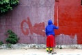 Worker paints an old wall with fresh paint