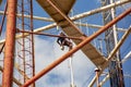 Worker paints pipes at height, industrial mountaineering, painting tall buildings and objects