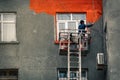 Worker paints the wall of a residential house
