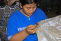 Worker paints wax with canting on Batik wax stamp in Winotosastro factory in Yogyakarta, Java, Indonesia