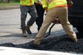 Worker paving the road with asphalt