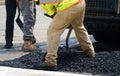 Worker paving the road with asphalt
