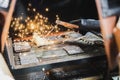 Worker perform electric metal welding in workshop class with a lots of spark. Focus on the electrode.