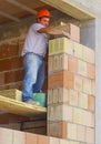Worker performs an external bricklayer wall