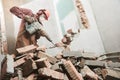 Worker with demolition hammer breaking interior wall Royalty Free Stock Photo