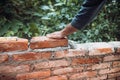 Worker placing and installing bricks on exterior wall on house construction Royalty Free Stock Photo