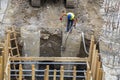 Worker placing water pump to drain trench Royalty Free Stock Photo