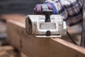 Worker planing a wood with a electric plane Royalty Free Stock Photo