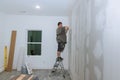A worker plasterers plasterboard walls in new room Royalty Free Stock Photo