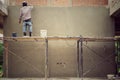 Worker plastering the brickwork wall by mixed cement