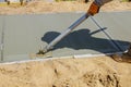 Worker plastering the concrete cement during sidewalk Royalty Free Stock Photo