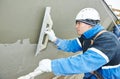 Worker at plastering facade work Royalty Free Stock Photo
