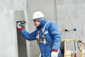 Worker at plastering facade work