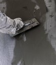 worker plastering tool plaster marble on interior plaster rough. Selective focus. Royalty Free Stock Photo