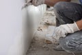 Worker plastering wall with putty knife indoors, closeup Royalty Free Stock Photo